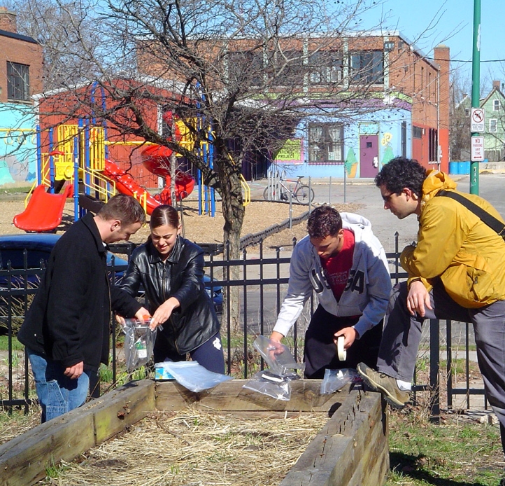 Students testing soil in a city garden