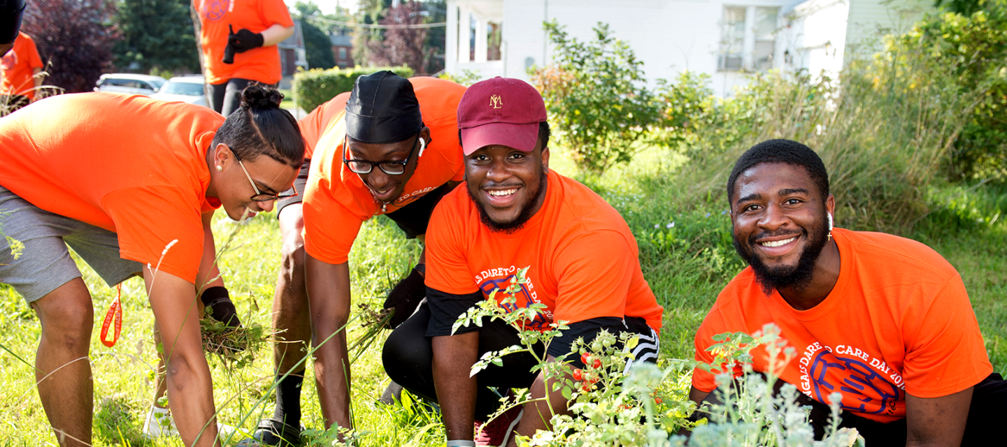 Students working in a garden on Dare to Care Day 